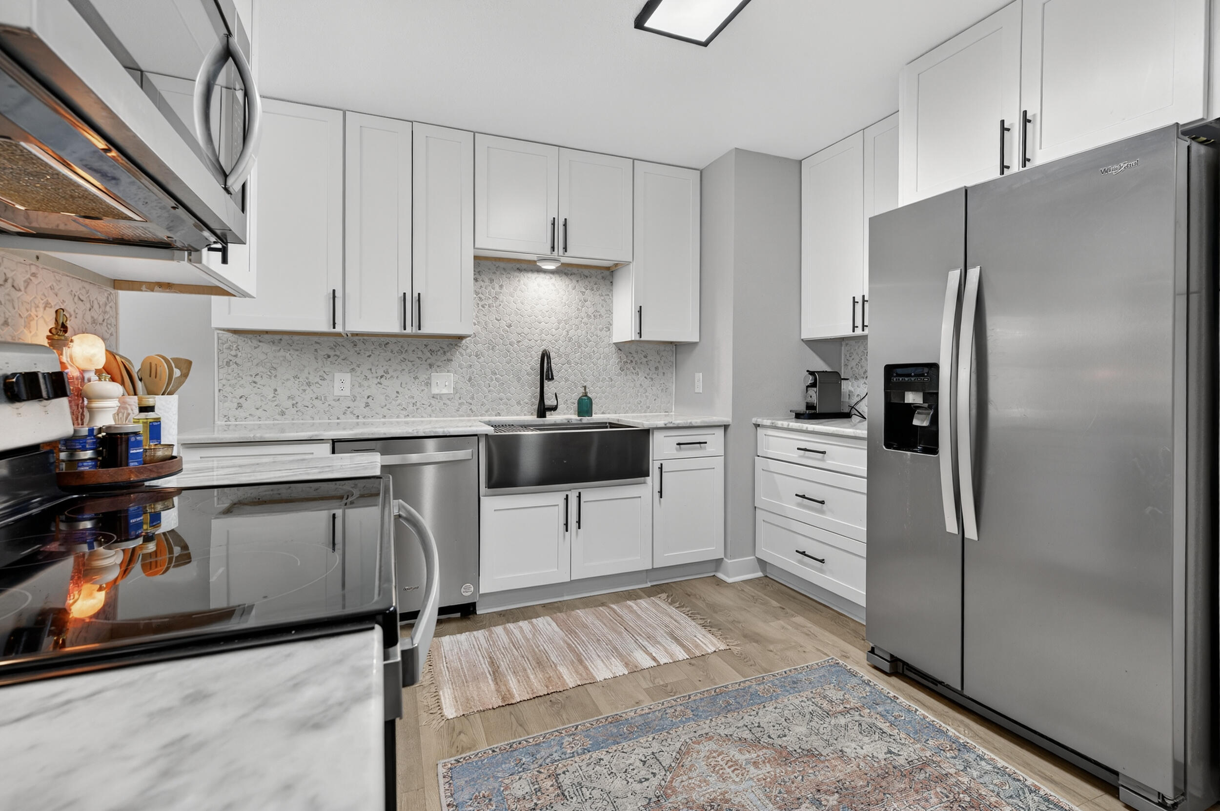 370 Edge Avenue Valparaiso, FL 32580 - Photo 5 of 58 a kitchen with granite countertop a refrigerator oven a sink and white cabinets