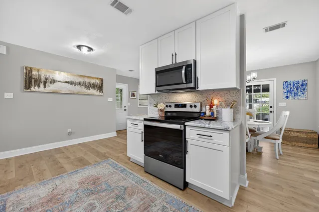a living room with furniture ceiling fan and a fireplace