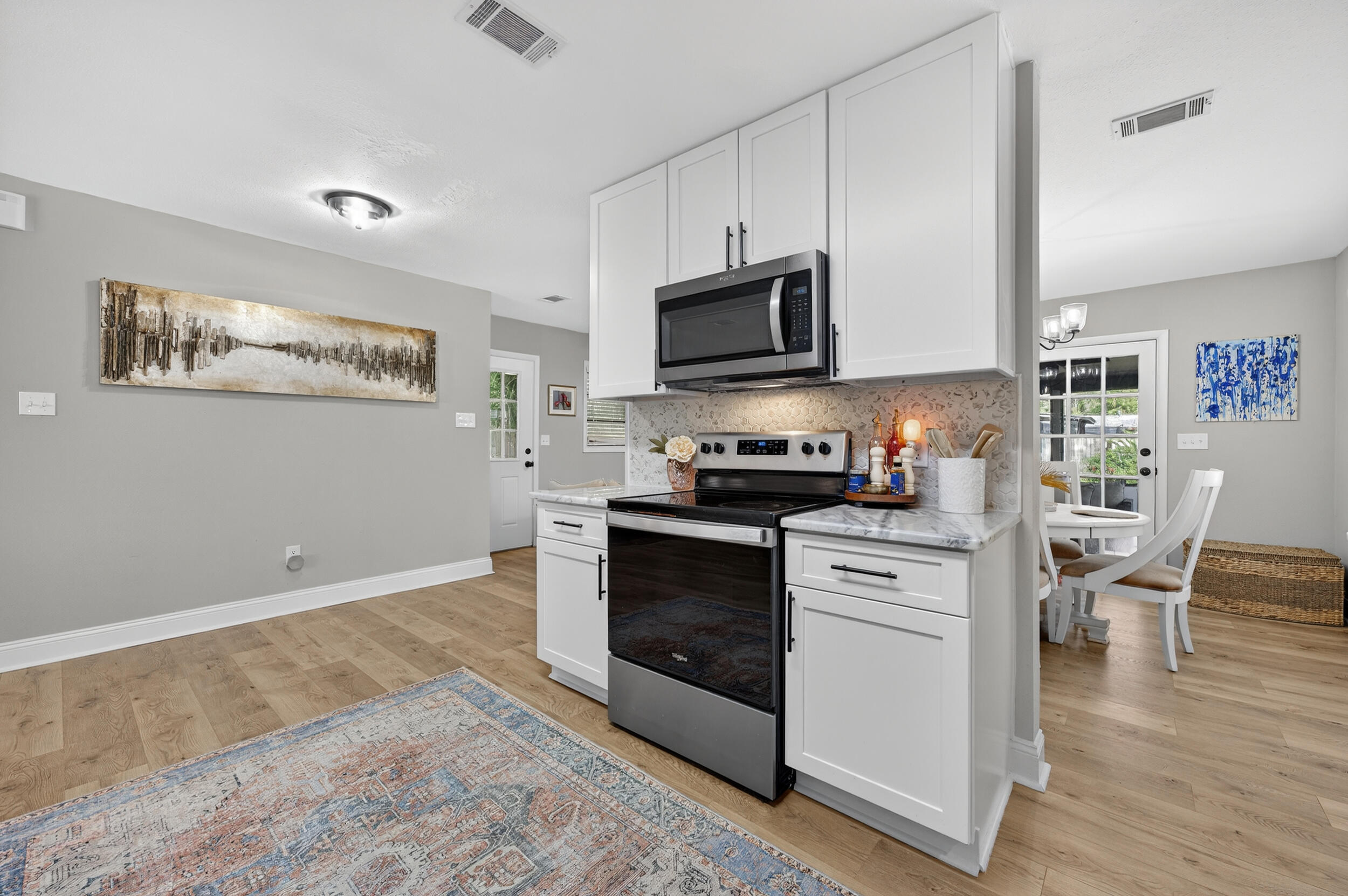 370 Edge Avenue Valparaiso, FL 32580 - Photo 6 of 58 a kitchen with stainless steel appliances granite countertop a stove a sink and a refrigerator