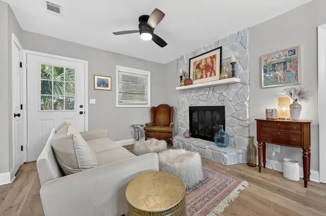 a view of a dining room with furniture a rug and wooden floor