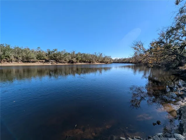 a view of a lake with houses in the background