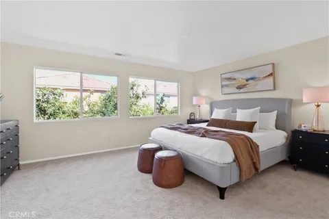 a spacious bedroom with a bed and window