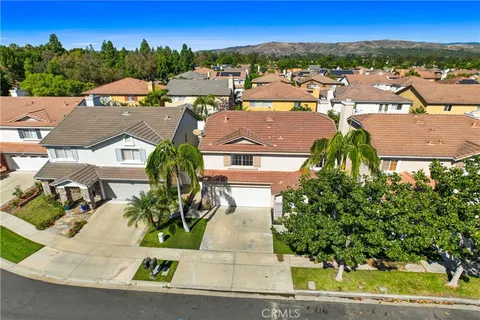 an aerial view of residential houses with outdoor space and street view