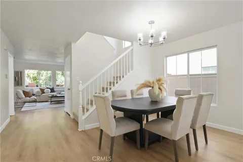 a view of a dining room with furniture and a chandelier