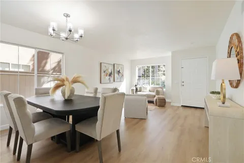 a view of a dining room with furniture and chandelier