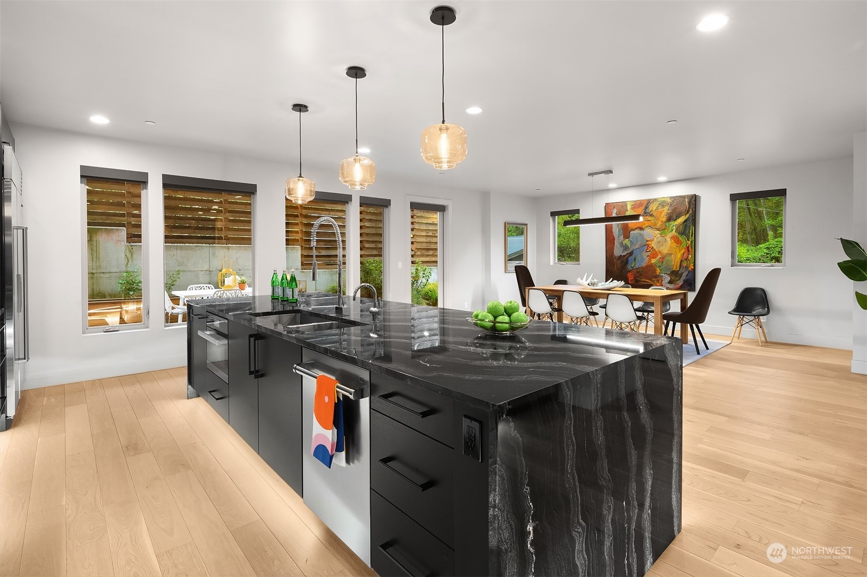 4312 West Cramer Street Seattle, WA 98199 - Photo 15 of 40 a kitchen with stainless steel appliances granite countertop a stove a sink and a wooden floors