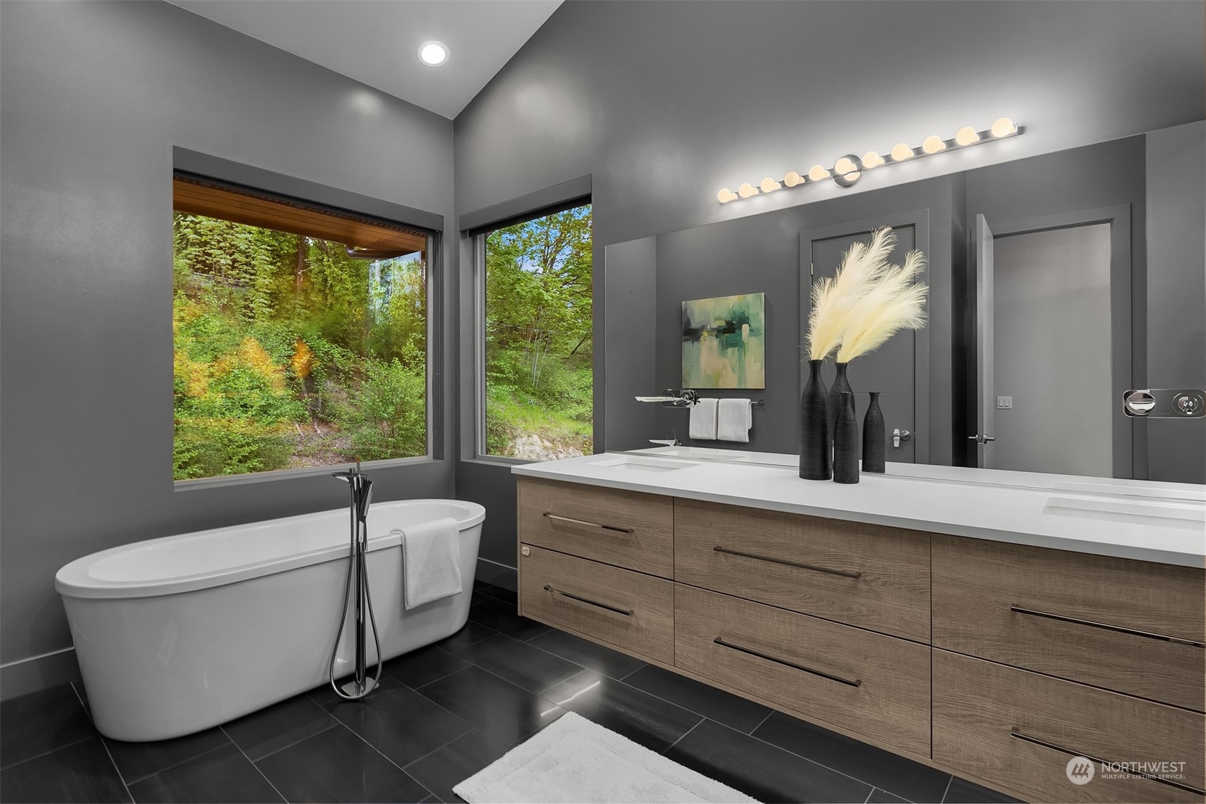 4312 West Cramer Street Seattle, WA 98199 - Photo 23 of 40 a bathroom with a double vanity sink a large mirror and a bathtub