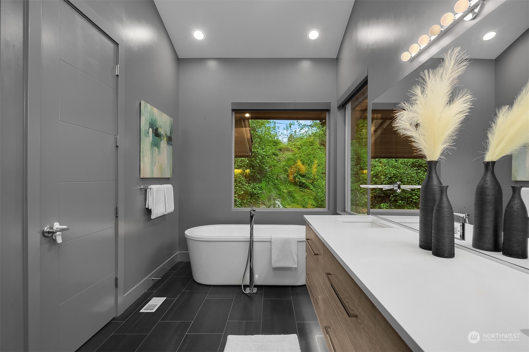 4312 West Cramer Street Seattle, WA 98199 - Photo 24 of 40 a bathroom with a sink and a large mirror