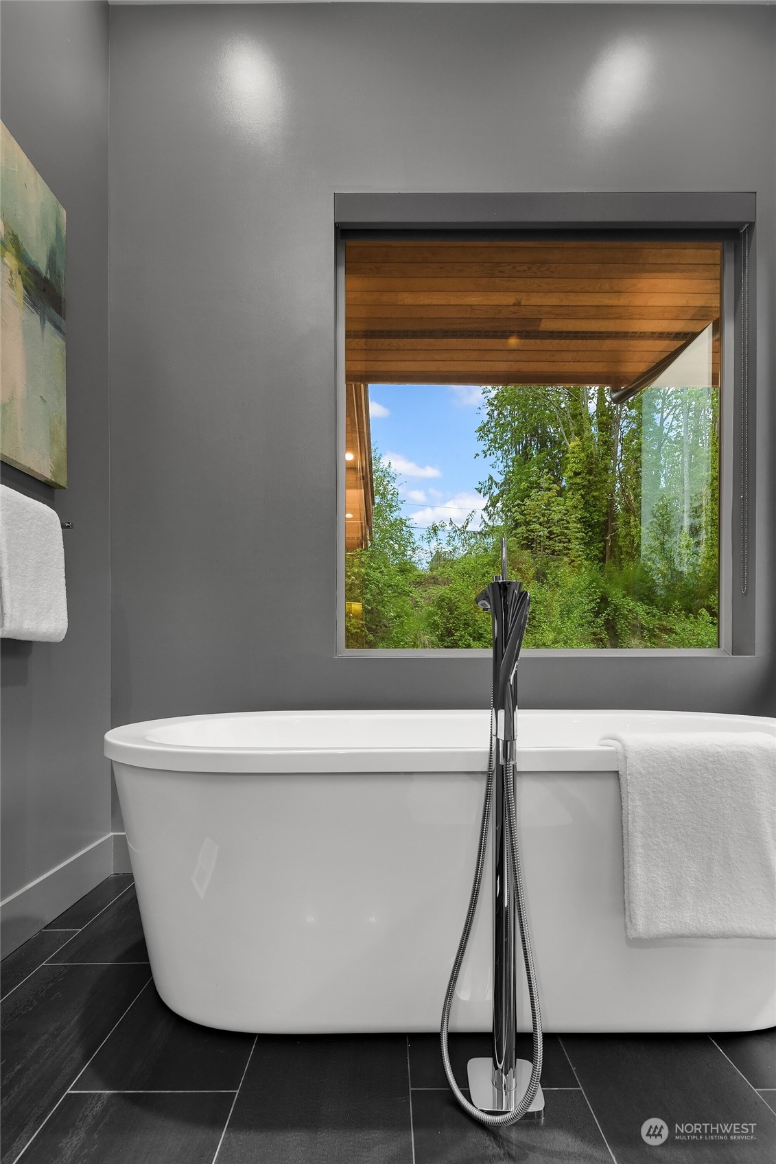 4312 West Cramer Street Seattle, WA 98199 - Photo 25 of 40 a white bath tub sitting in a bathroom