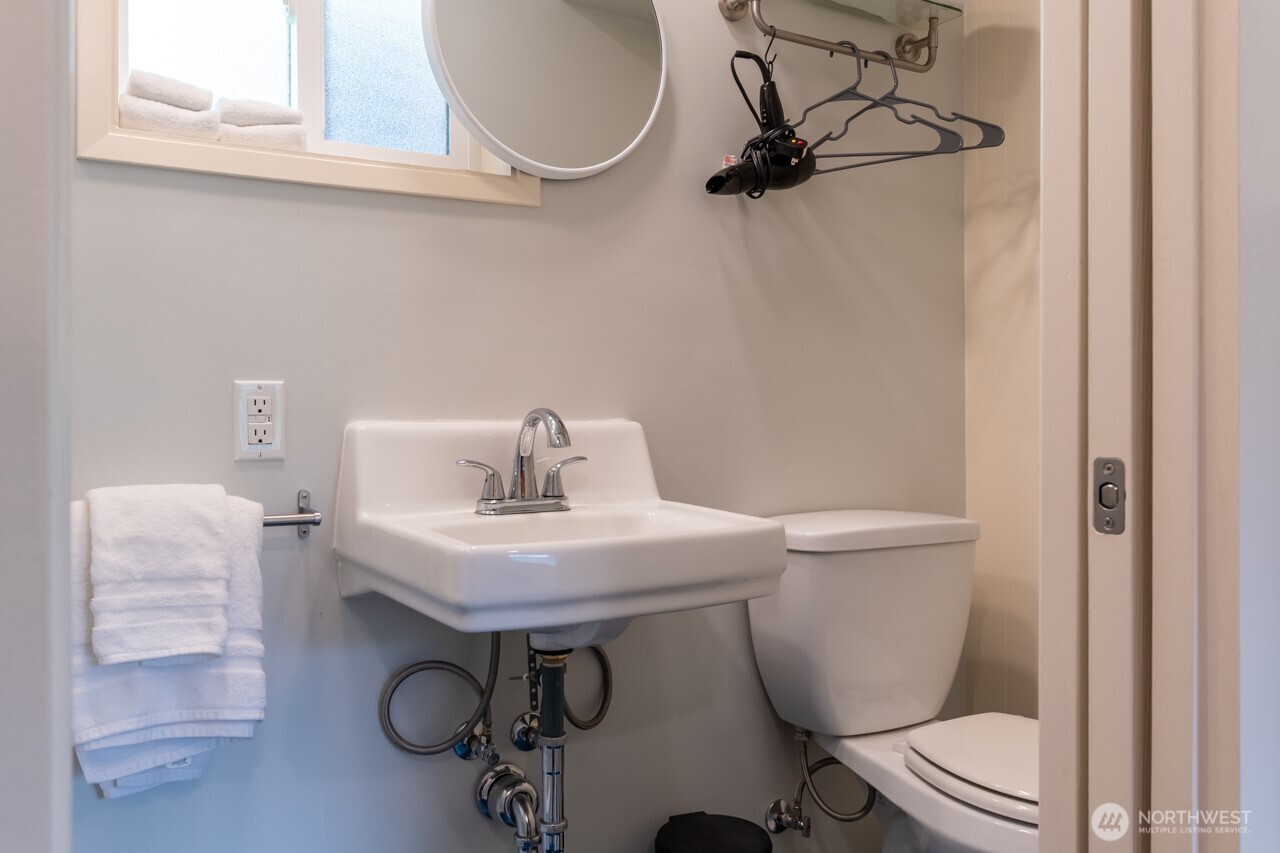 63 East Arnette Road Port Angeles, WA 98362 - Photo 38 of 40 a bathroom with a sink a toilet and a mirror