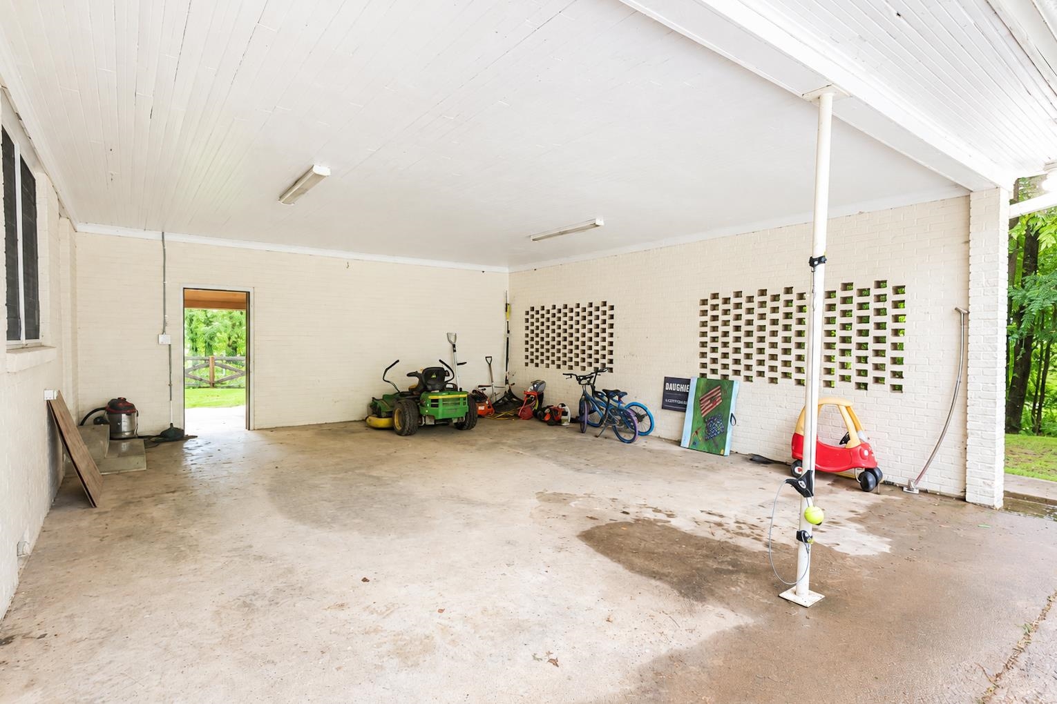10093 Mt Carmel Road Brighton, TN 38011 - Photo 4 of 36 Spacious covered outdoor area featuring a concrete floor, painted brick walls, and a white tongue-and-groove ceiling