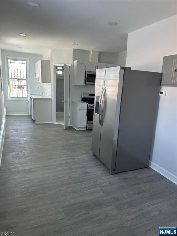 105 Broadway Newark, NJ 07104 - Photo 3 of 9 a view of a kitchen with refrigerator and wooden floor