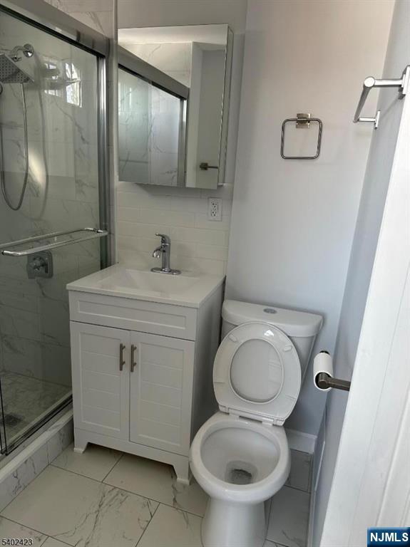 105 Broadway Newark, NJ 07104 - Photo 5 of 9 a bathroom with a toilet sink and mirror