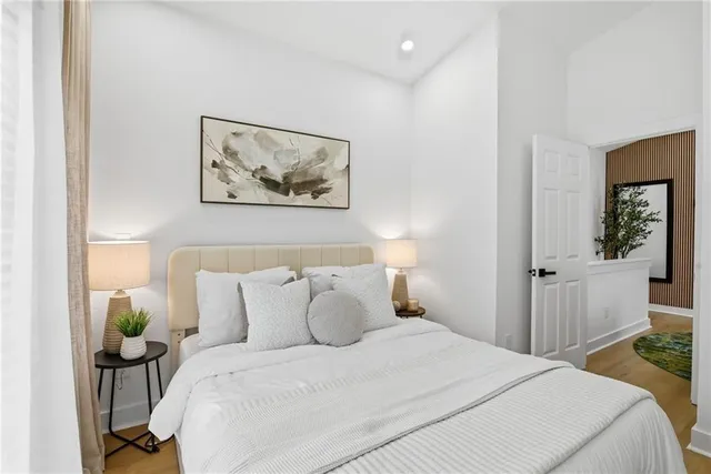 a bedroom with a bed and a painting on the wall