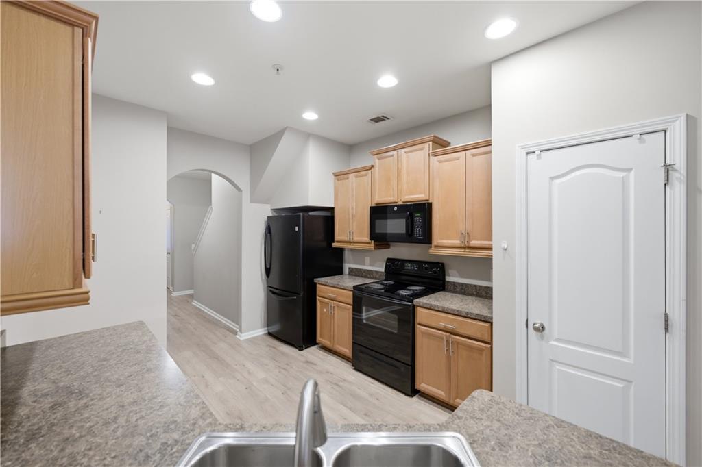 535 Ridge View Crossing Woodstock, GA 30188 - Photo 11 of 45 a kitchen with stainless steel appliances granite countertop a refrigerator stove and sink