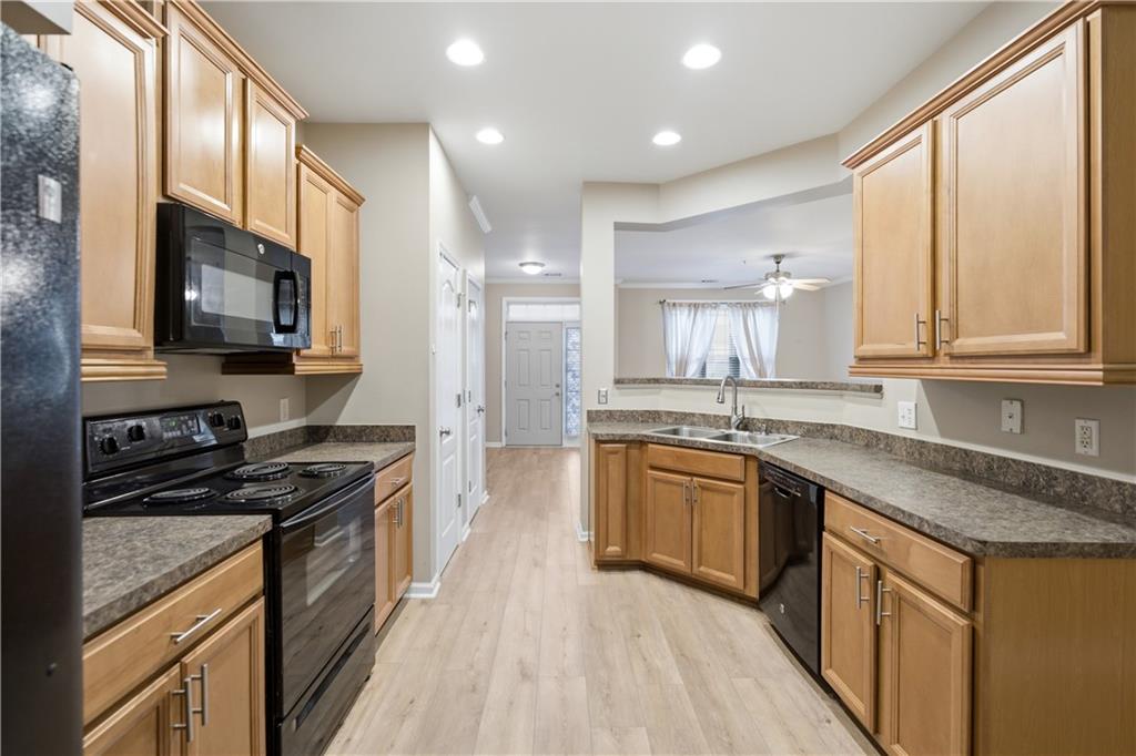 535 Ridge View Crossing Woodstock, GA 30188 - Photo 12 of 45 a kitchen with stainless steel appliances granite countertop a stove a sink and a microwave