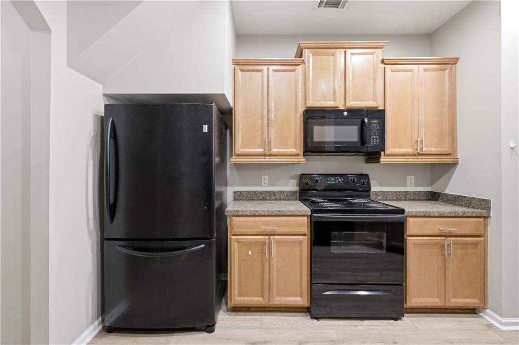 535 Ridge View Crossing Woodstock, GA 30188 - Photo 13 of 45 a kitchen with a refrigerator and a stove