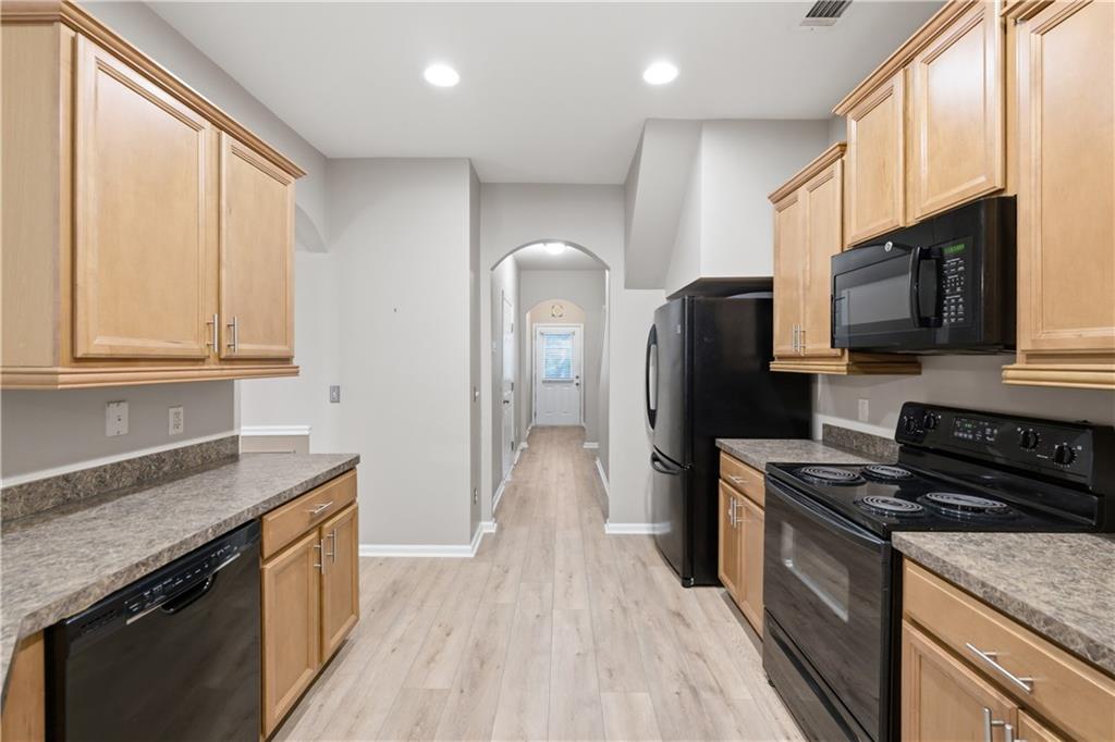 535 Ridge View Crossing Woodstock, GA 30188 - Photo 14 of 45 a kitchen with stainless steel appliances granite countertop a stove a sink and a refrigerator