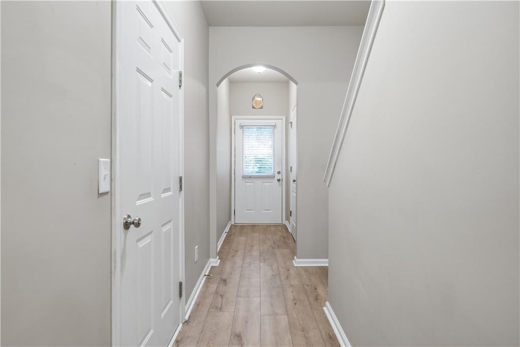 535 Ridge View Crossing Woodstock, GA 30188 - Photo 15 of 45 a view of a hallway with wooden floor and a bathroom