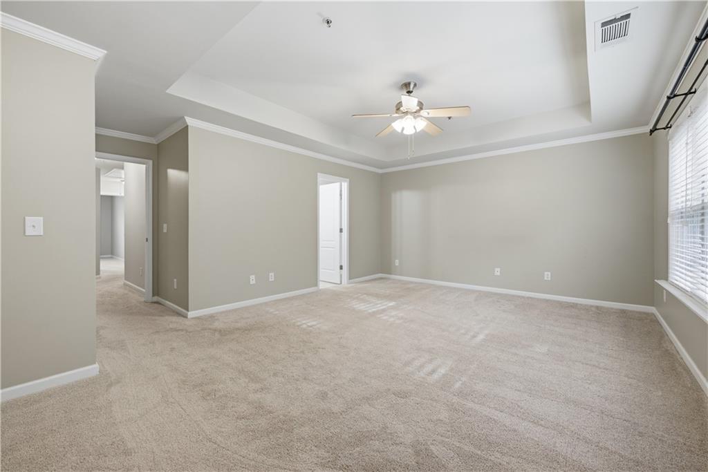 535 Ridge View Crossing Woodstock, GA 30188 - Photo 19 of 45 an empty room with chandelier fan and windows