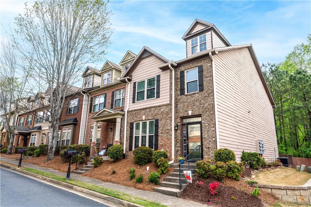 535 Ridge View Crossing Woodstock, GA 30188 - Photo 2 of 45 a view of a white house with large windows and a table and chairs