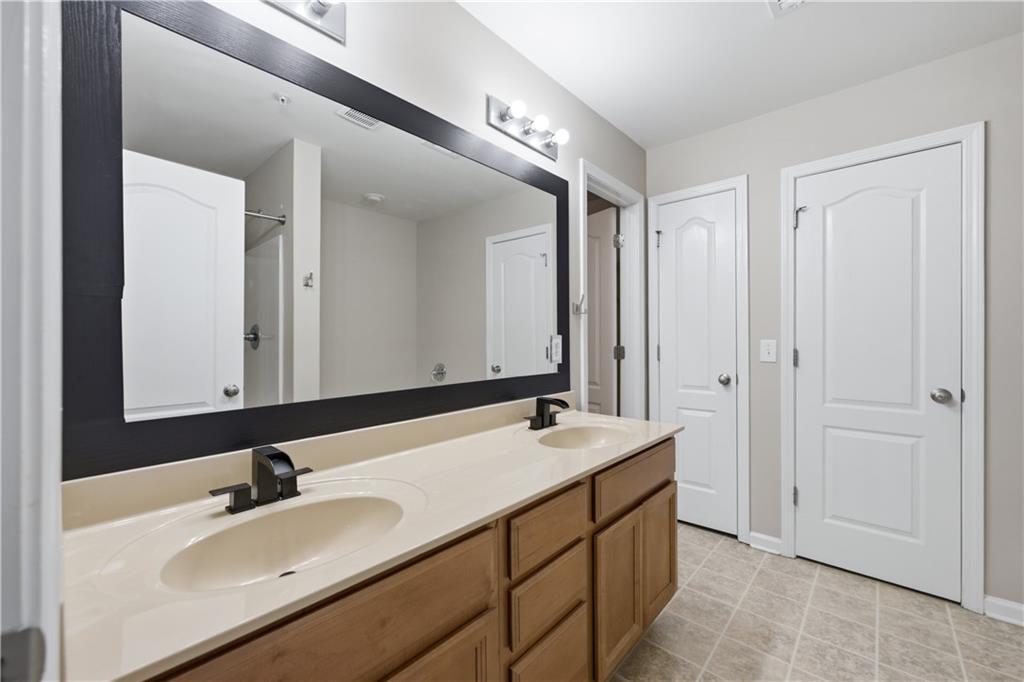 535 Ridge View Crossing Woodstock, GA 30188 - Photo 21 of 45 a bathroom with a sink and a mirror