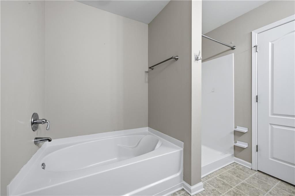 535 Ridge View Crossing Woodstock, GA 30188 - Photo 22 of 45 a white bath tub sitting next to a toilet