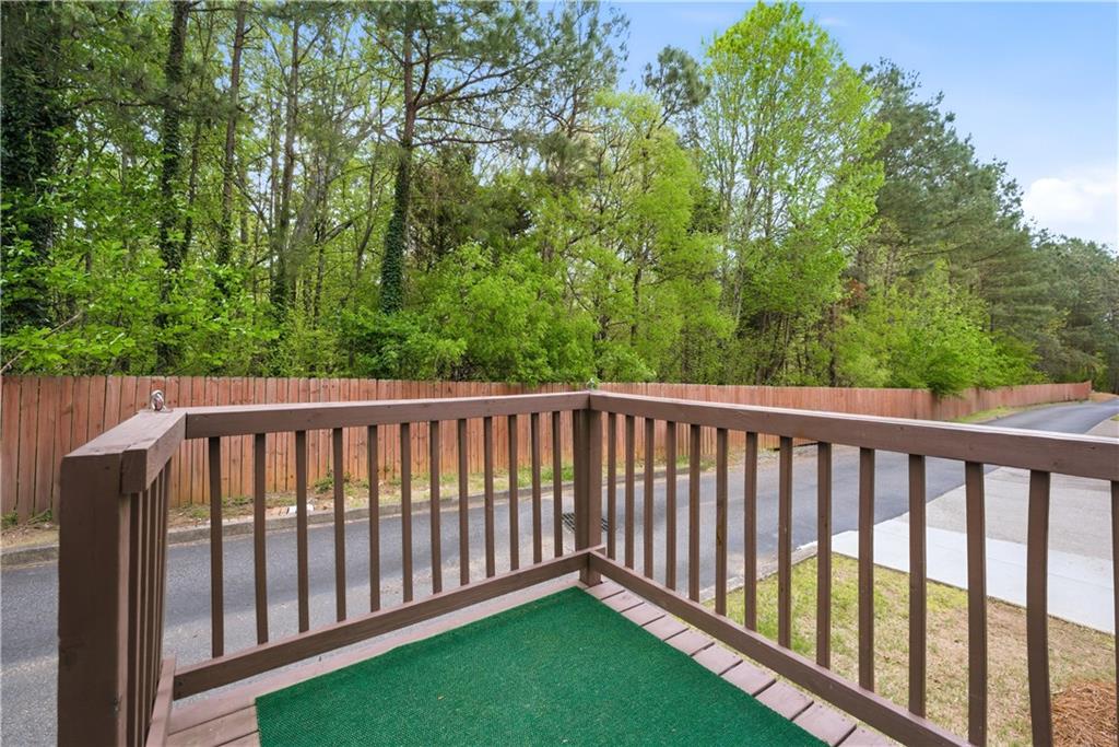 535 Ridge View Crossing Woodstock, GA 30188 - Photo 31 of 45 a balcony with wooden floor and trees in the back