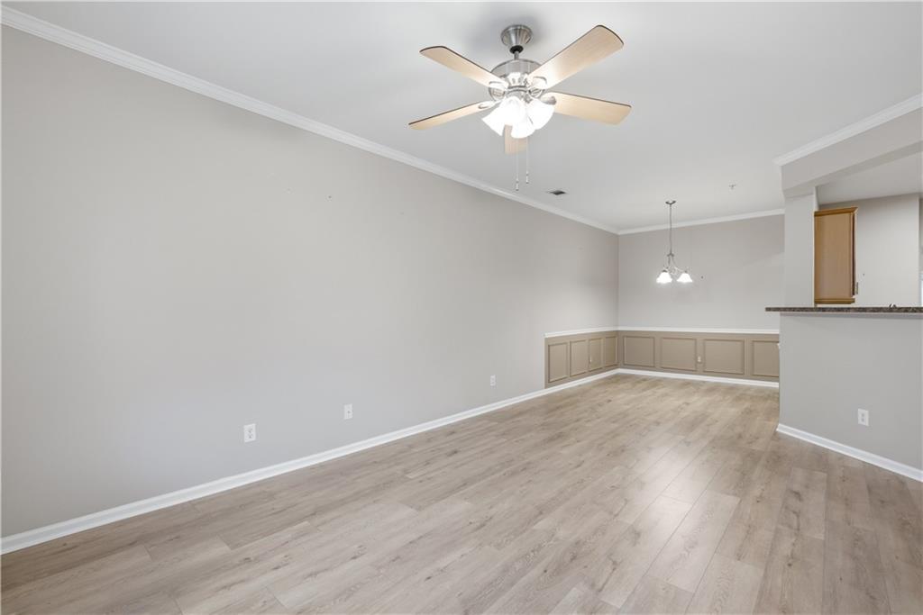 535 Ridge View Crossing Woodstock, GA 30188 - Photo 4 of 45 an empty room with wooden floor and fan