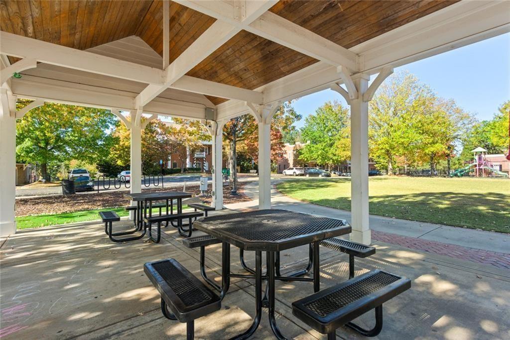 535 Ridge View Crossing Woodstock, GA 30188 - Photo 44 of 45 a view of a patio with table and chairs potted plants with wooden floor and fence