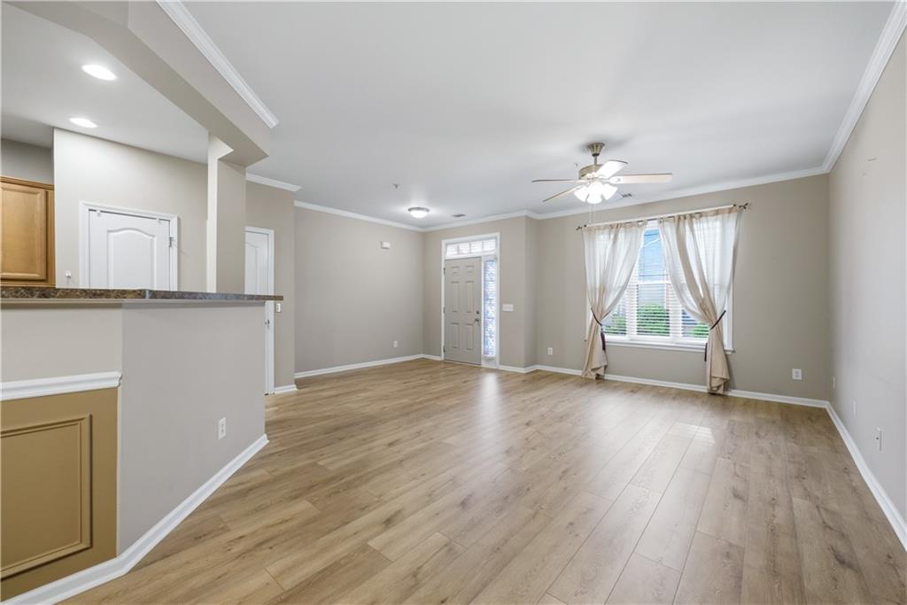 535 Ridge View Crossing Woodstock, GA 30188 - Photo 6 of 45 a view of an empty room with a window and wooden floor
