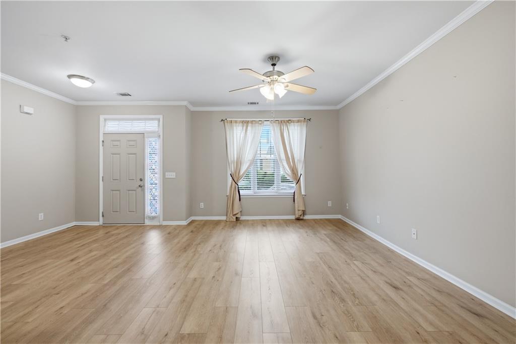 535 Ridge View Crossing Woodstock, GA 30188 - Photo 7 of 45 an empty room with wooden floor and windows