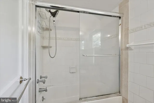 a bathroom with a glass shower door