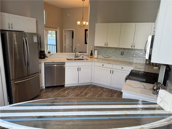 a kitchen with a sink appliances and cabinets