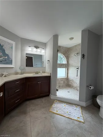 a bathroom with a granite countertop sink mirror and bathtub