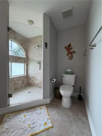 a bathroom with a toilet and a shower