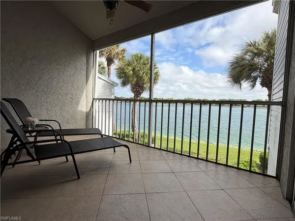 a view of a chairs and table in the balcony