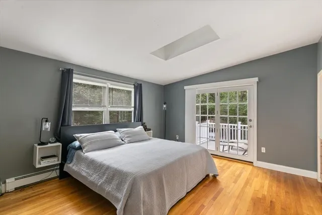 a bedroom with a large bed and a window