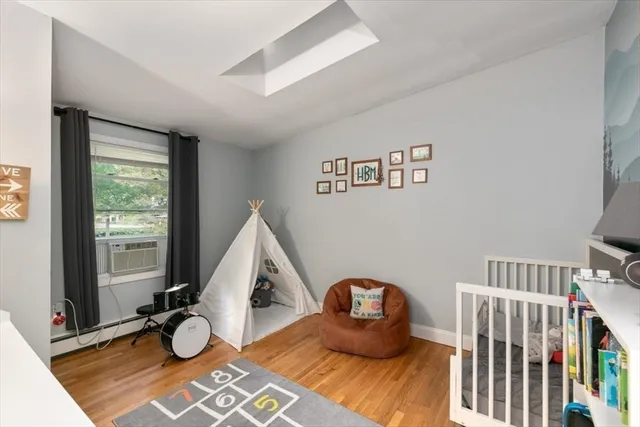 a view of room with wooden floor and windows