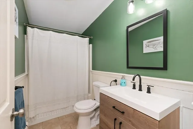 a bathroom with a sink mirror vanity and toilet