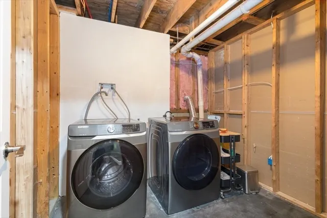 a view of a storage & utility room with dryer and washer