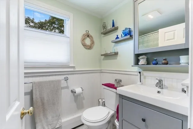 a bathroom with a sink mirror and toilet