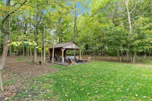 a backyard of a house with table and chairs
