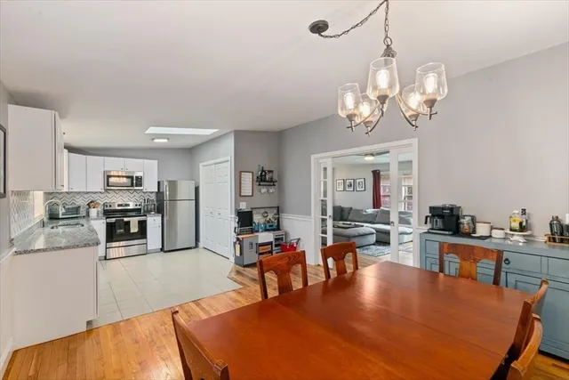 a living room with fireplace furniture and a chandelier