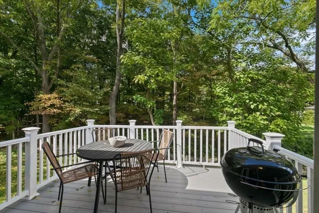 a view of balcony with wooden deck and outdoor seating