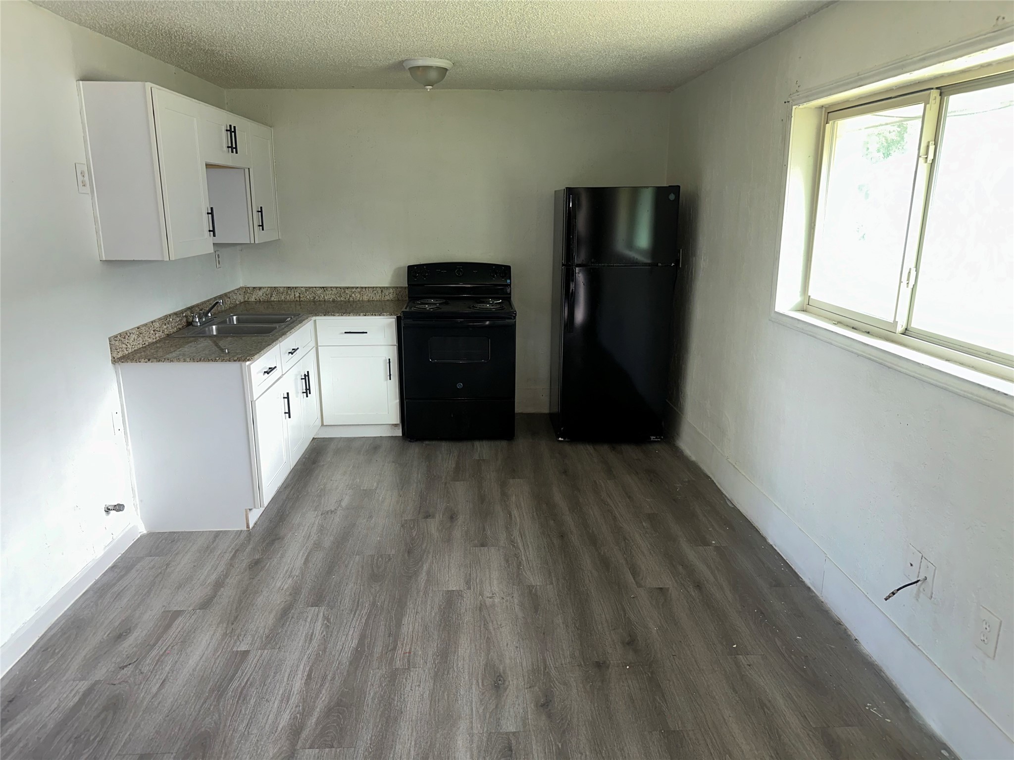 5405 Suez Street, Unit 4 Houston, TX 77020 - Photo 3 of 10 a kitchen with a refrigerator and window