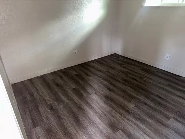 a view of room with wooden floor