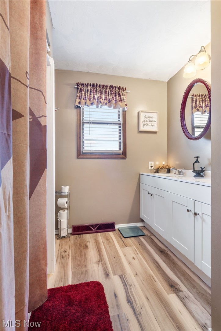 4398 Plymouth Springmill Road Shelby, OH 44875 - Photo 23 of 34 Bathroom with vanity and wood-type flooring