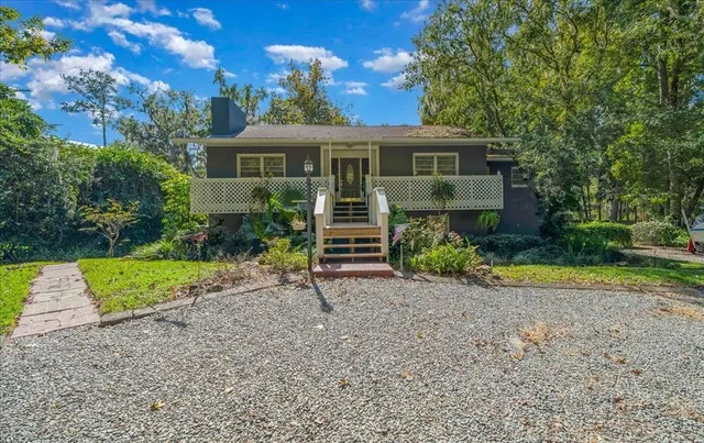 a front view of a house with a yard and porch