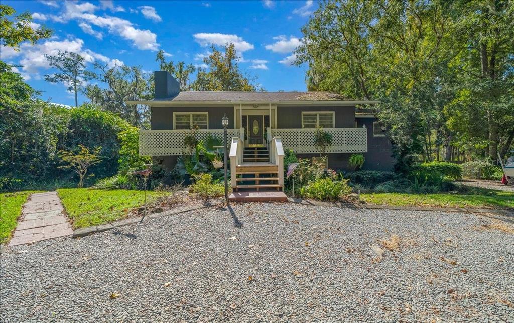 a front view of a house with a yard and porch